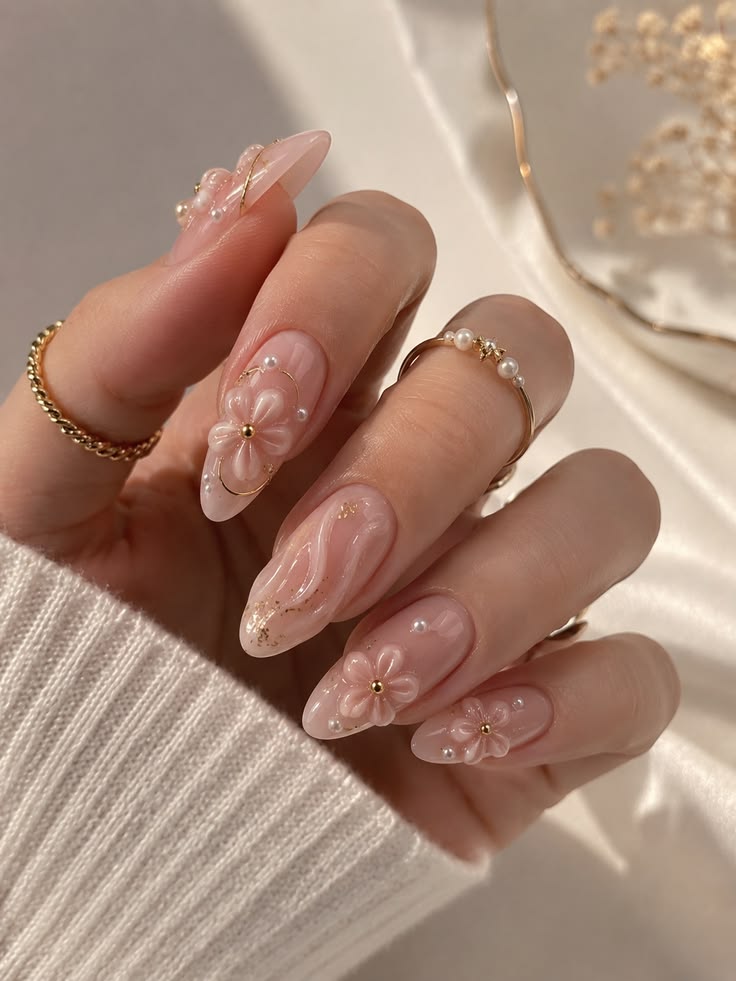 Hand-painted floral nail art with pearl detailing